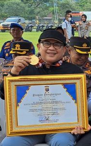 Foto Ketua PWI Riau H. Zulmansyah Sekedang menerima medali penghargaan dari Kapolda Riau.