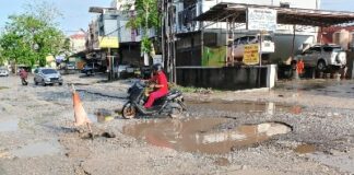 Foto : Keadaan Jalan Dharma Bakti Kelurahan Bandar Raya Kecamatan Payung Sekaki yang berlubang, sering tergenang air dan rusak parah.